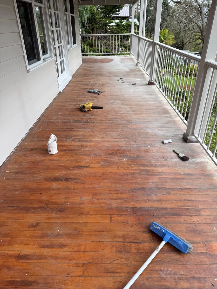 Deck being stained with tools laid out
