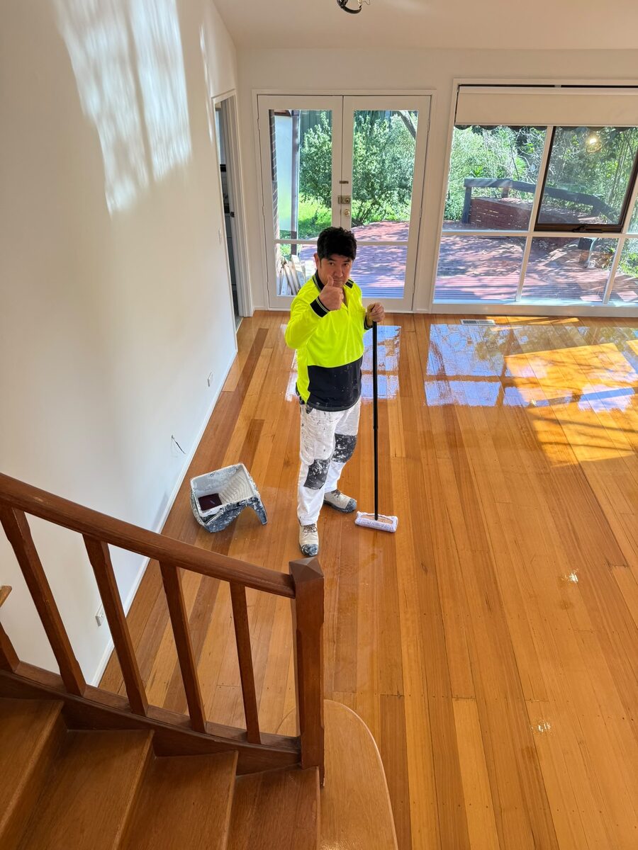 Painter varnishing a timber floor