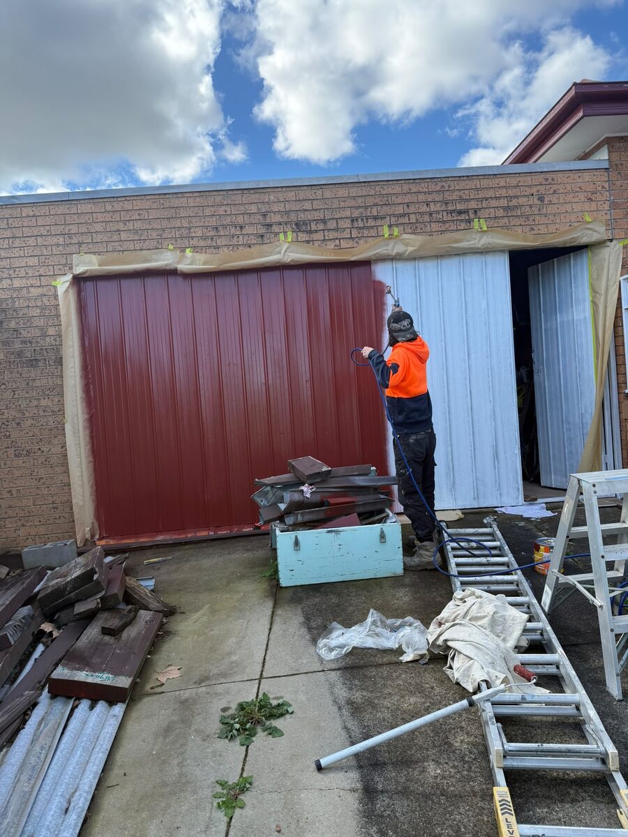 Garage doors being spray painted red