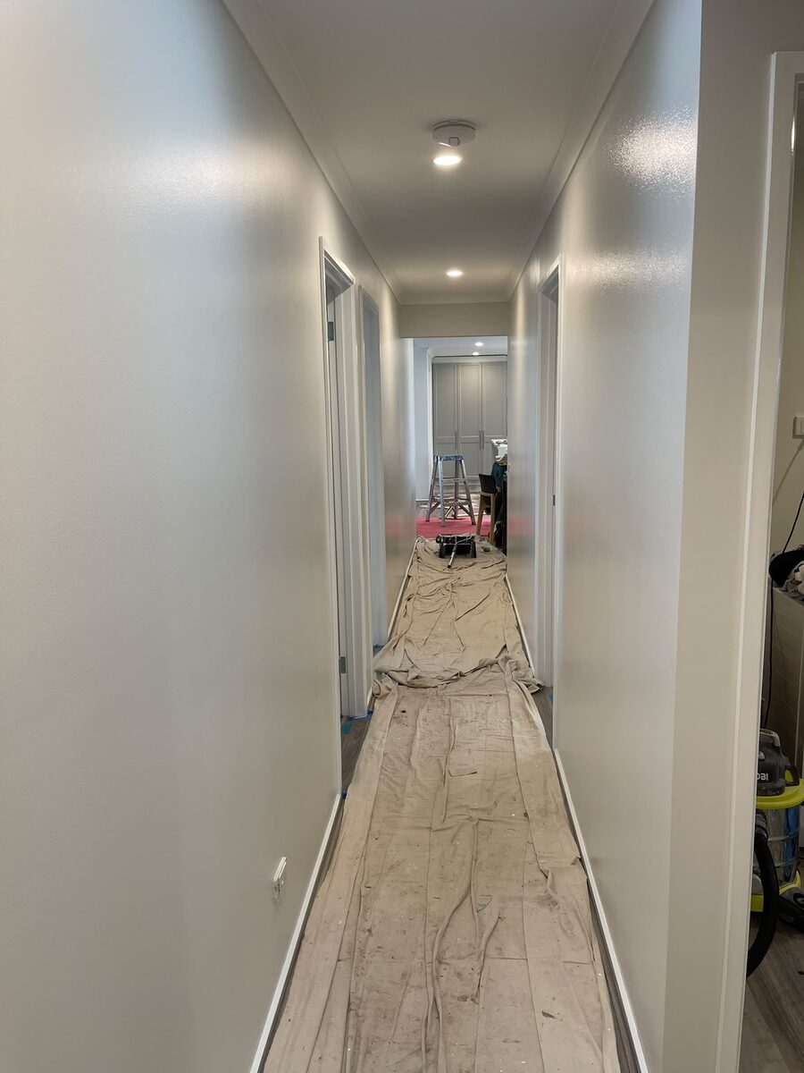 Interior hallway repainted and sheeted during work